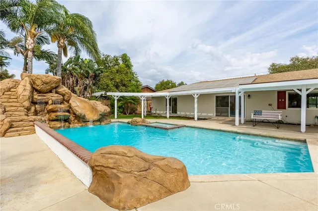 a living room with furniture and kitchen view