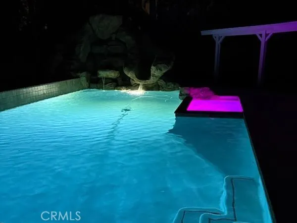 a bathroom with a toilet a sink a mirror and a window