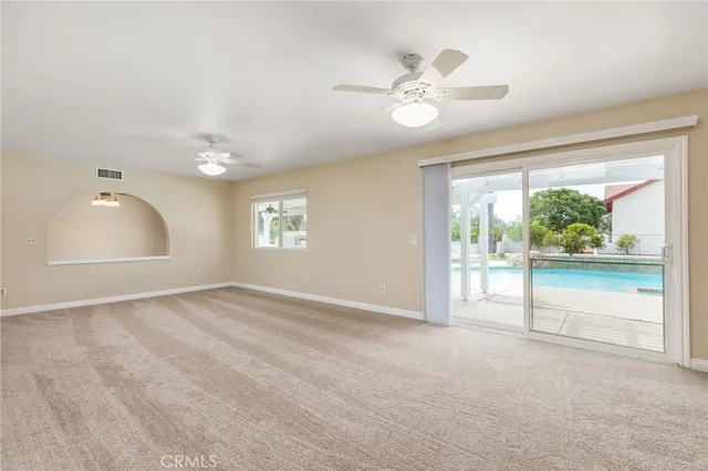 a kitchen with granite countertop a sink window and cabinets