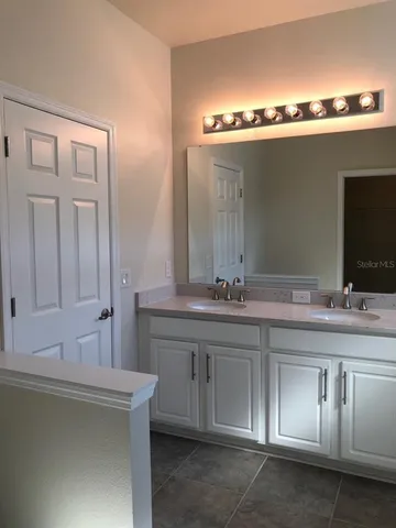 a bathroom with a sink and mirror