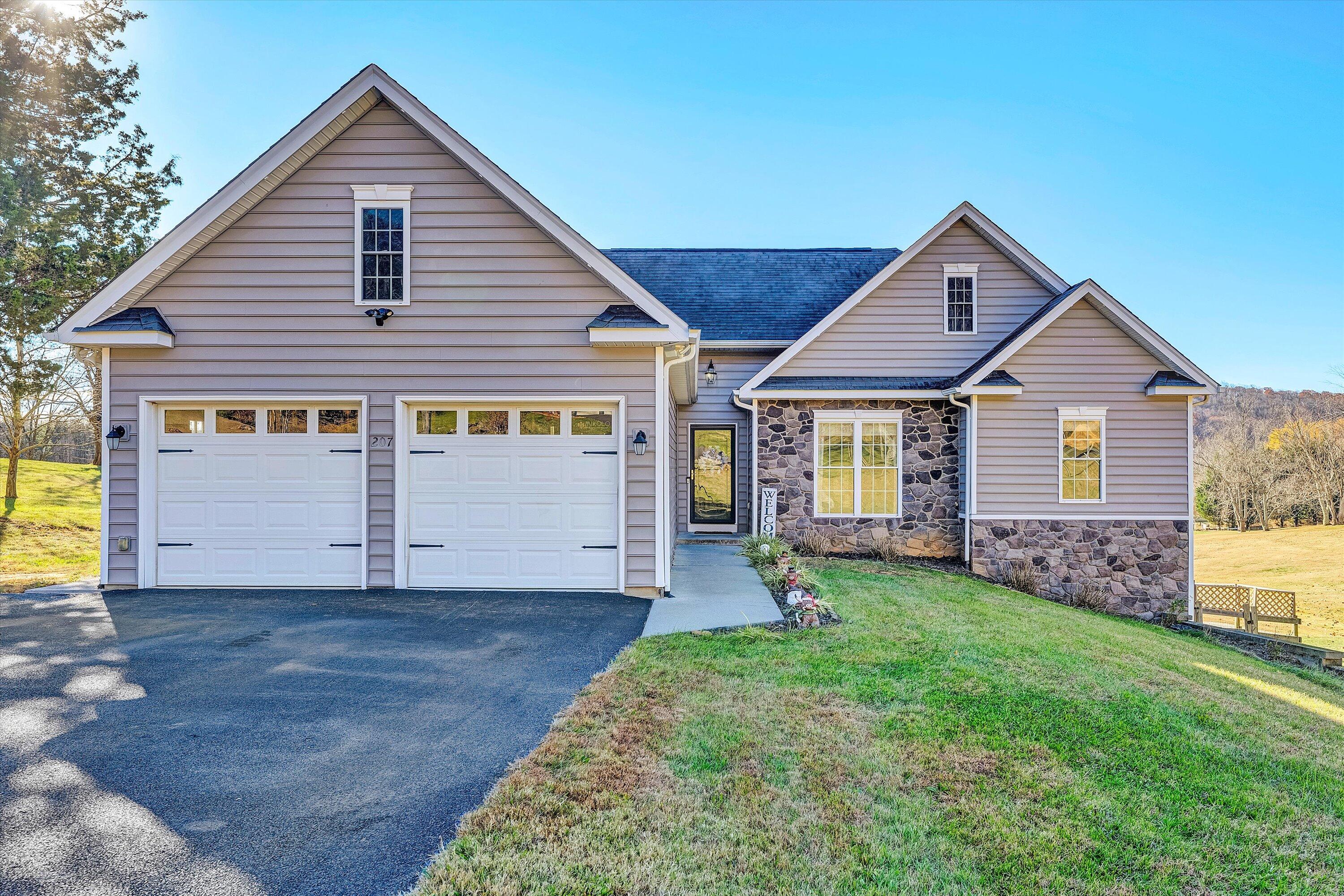 a front view of a house with a yard and garage