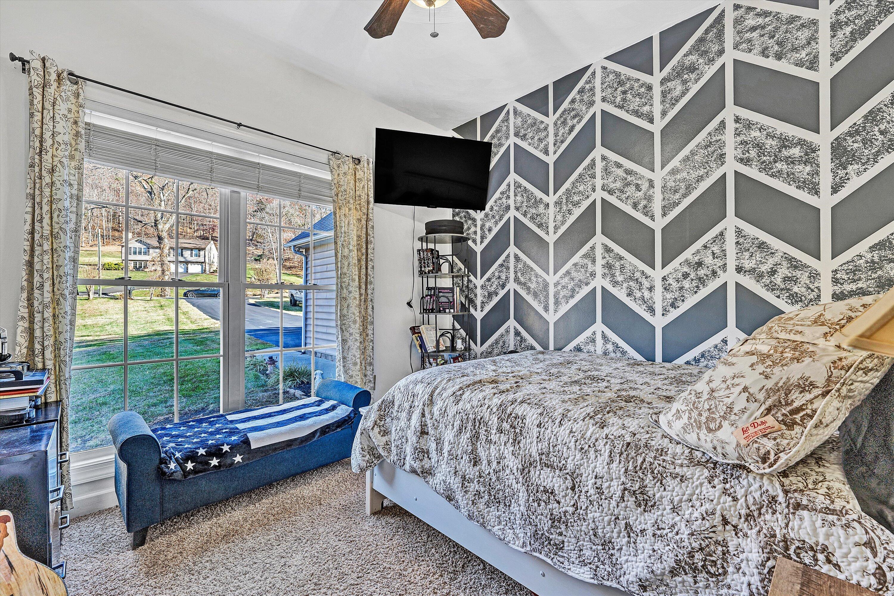 207 Overlook Road Vinton, VA 24179 - Photo 21 of 65 a bed sitting in a bedroom next to a window with a flat screen tv