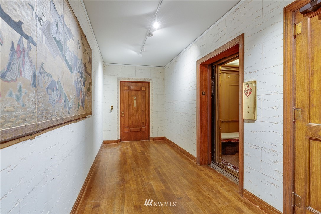 1223 Spring Street, Unit 1001 Seattle, WA 98104 - Photo 3 of 38 a view of hallway with wooden floor