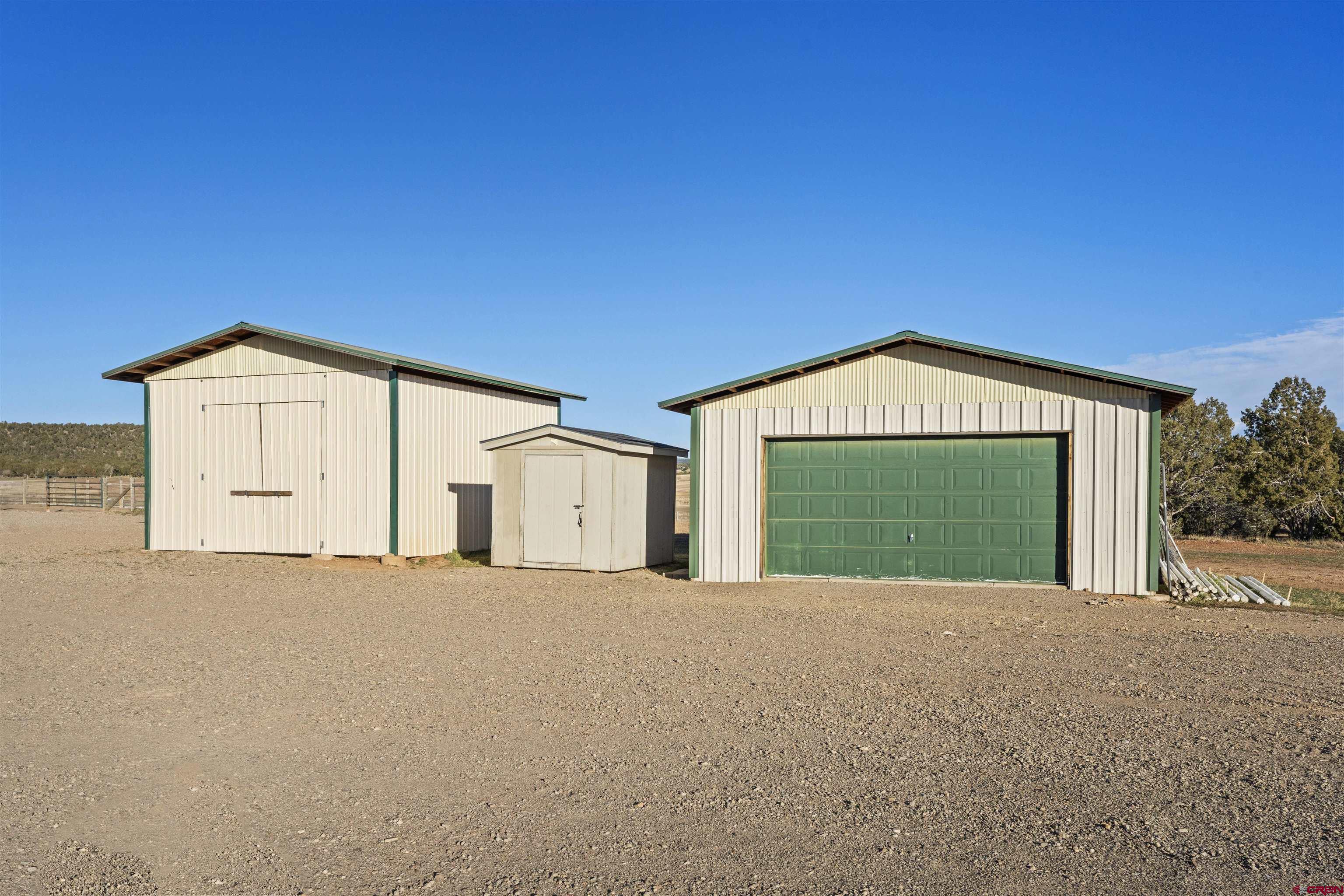 1302 42zn Road Norwood, CO 81423 - Photo 23 of 32 a view of a house with a yard and garage