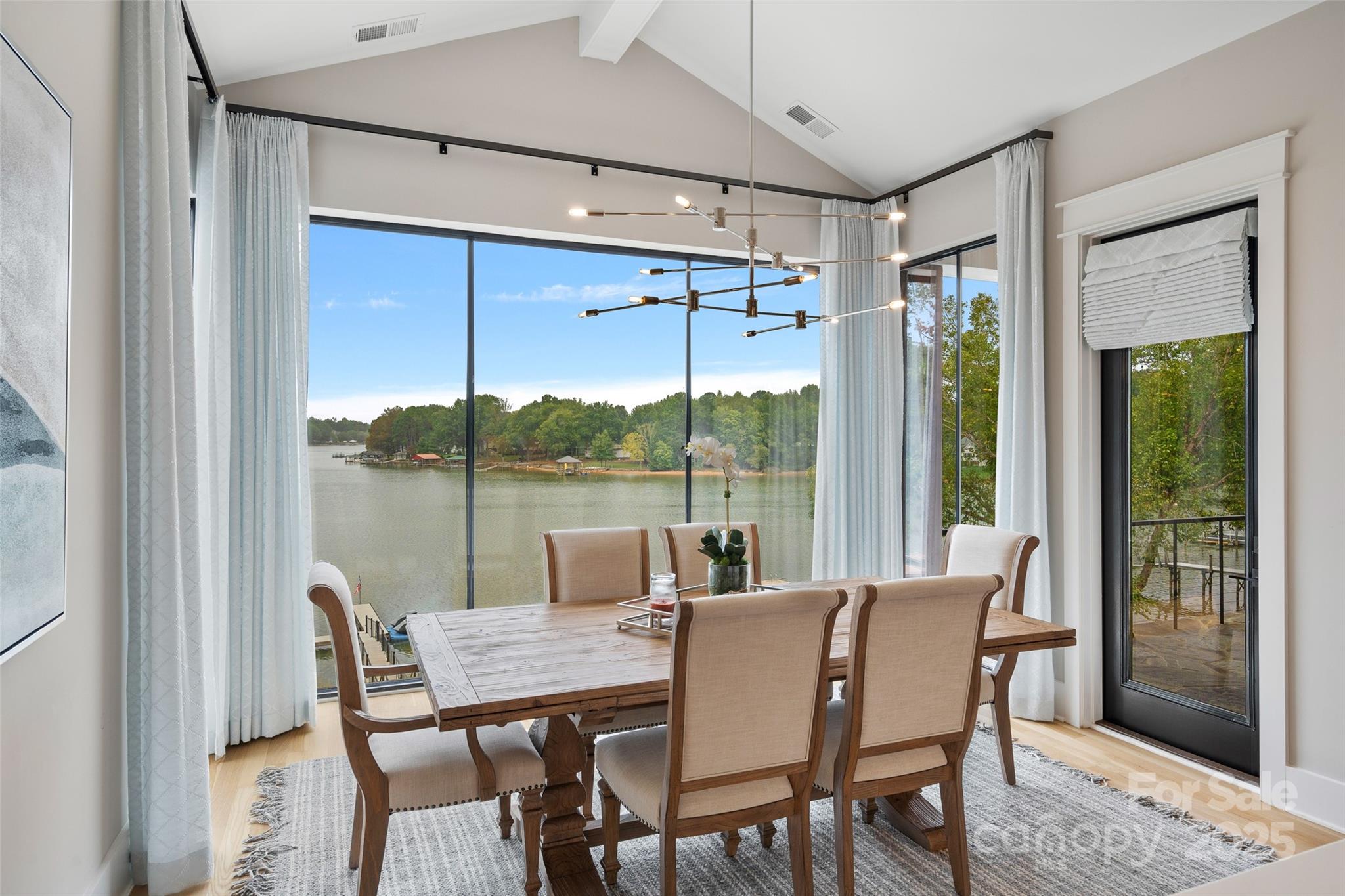 505 Kemp Road Mooresville, NC 28117 - Photo 11 of 38 a dining room with furniture large windows and a chandelier