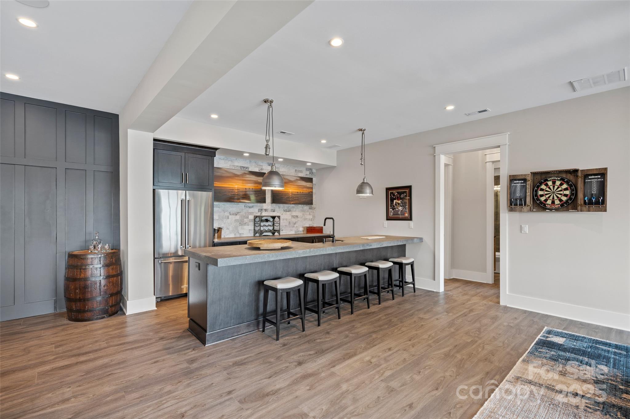 505 Kemp Road Mooresville, NC 28117 - Photo 23 of 38 a kitchen with stainless steel appliances a dining table chairs and wooden floor