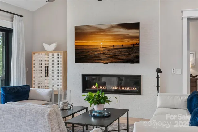 a living room with furniture windows and a flat screen tv