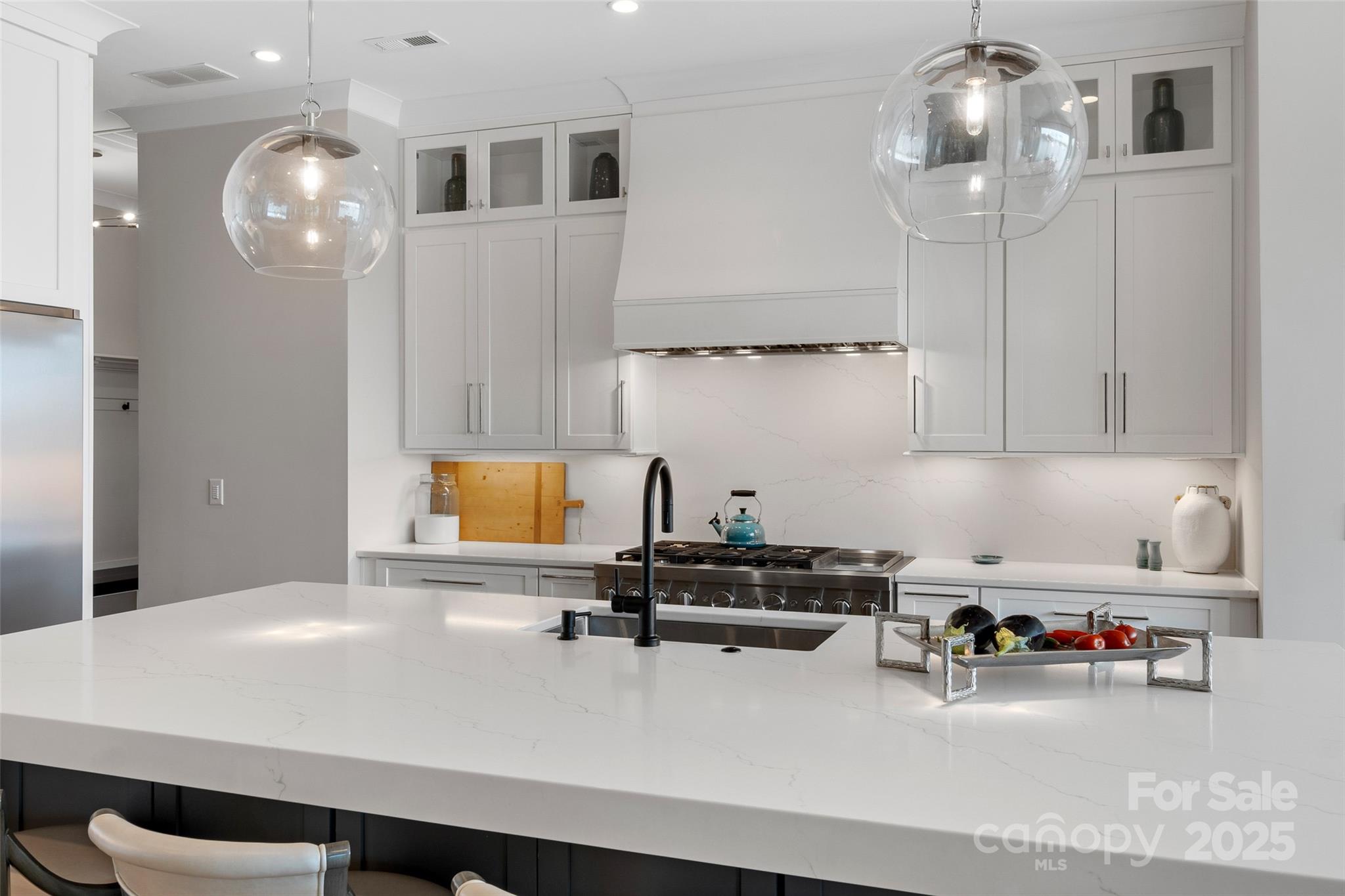 505 Kemp Road Mooresville, NC 28117 - Photo 9 of 38 a kitchen with a sink a cabinets and chairs