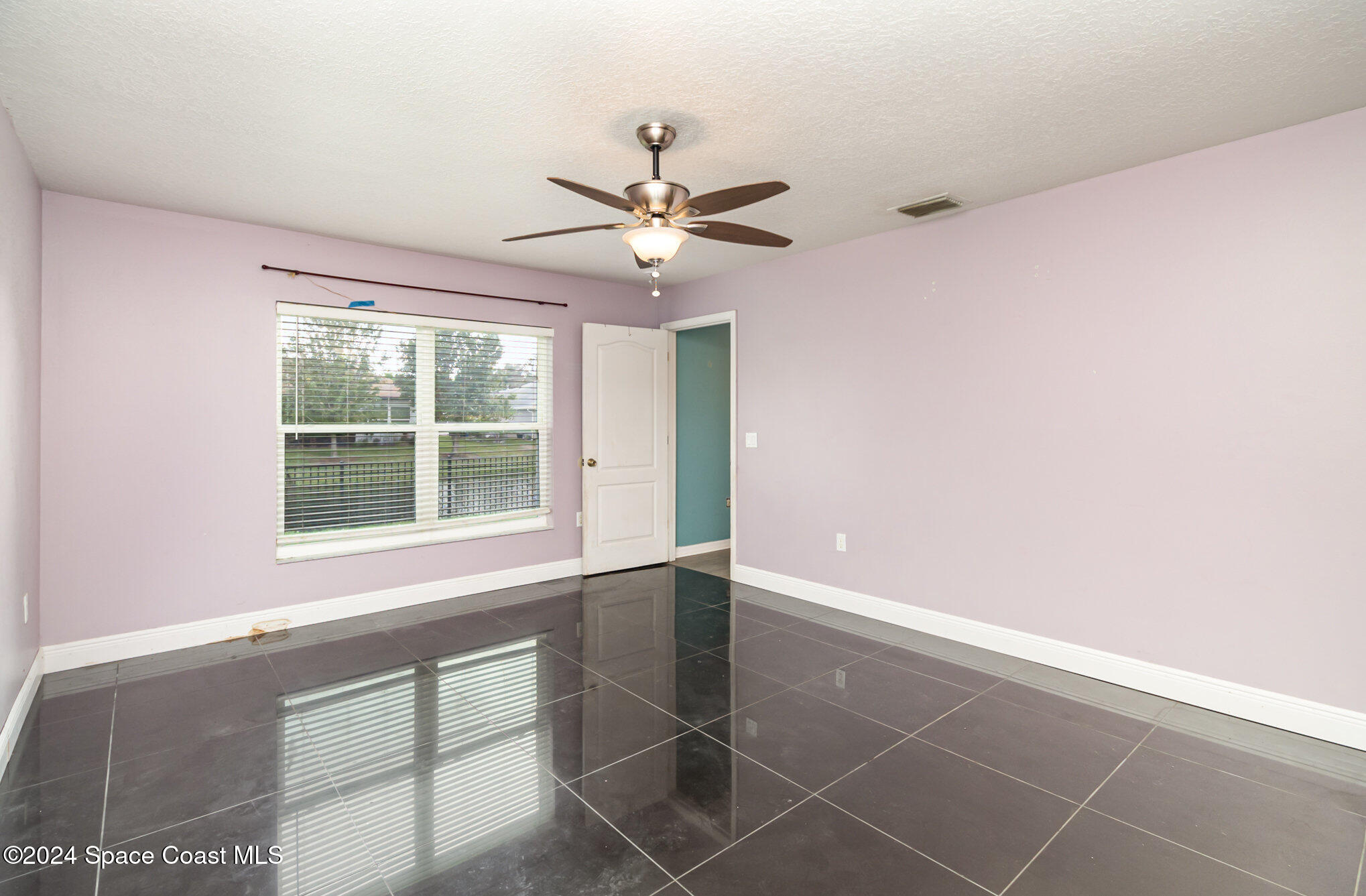 1223 Winding Meadows Road Rockledge, FL 32955 - Photo 14 of 27 an empty room with windows and fan