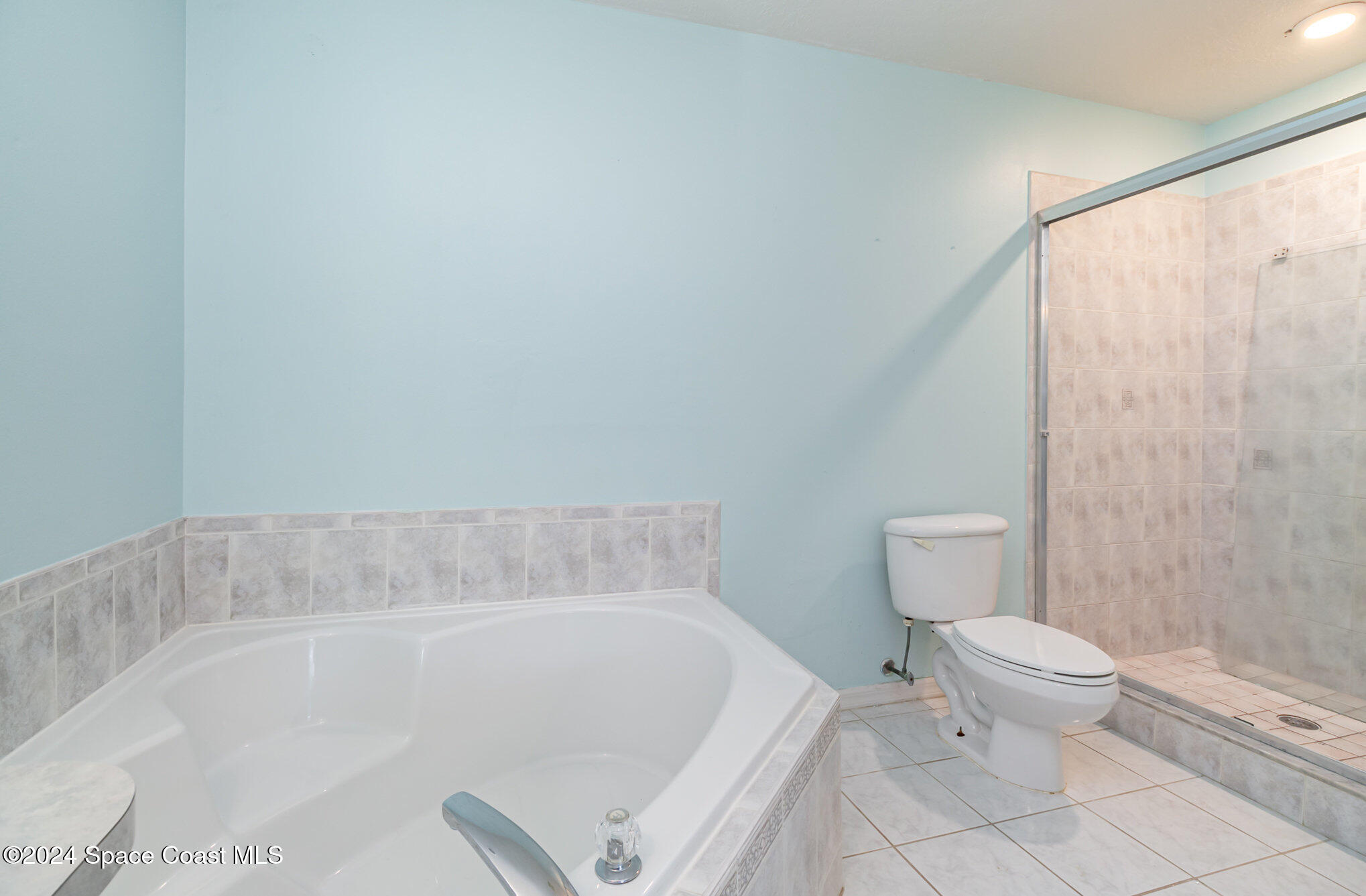 1223 Winding Meadows Road Rockledge, FL 32955 - Photo 17 of 27 a white bath tub sitting next to a white toilet