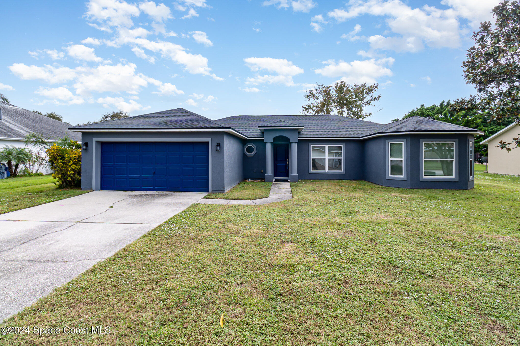 1223 Winding Meadows Road Rockledge, FL 32955 - Photo 3 of 27 front view of a house with a yard