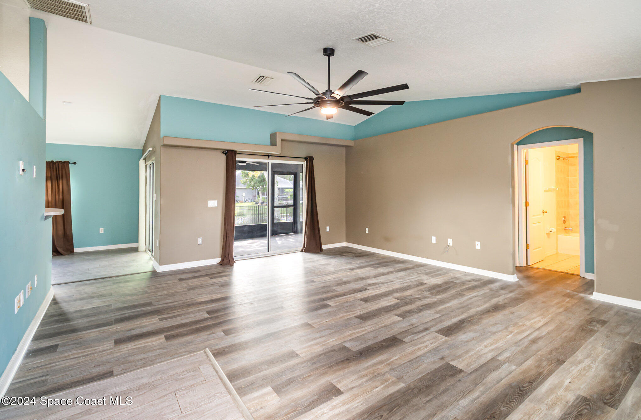 1223 Winding Meadows Road Rockledge, FL 32955 - Photo 4 of 27 a view of an empty room with window and a ceiling fan