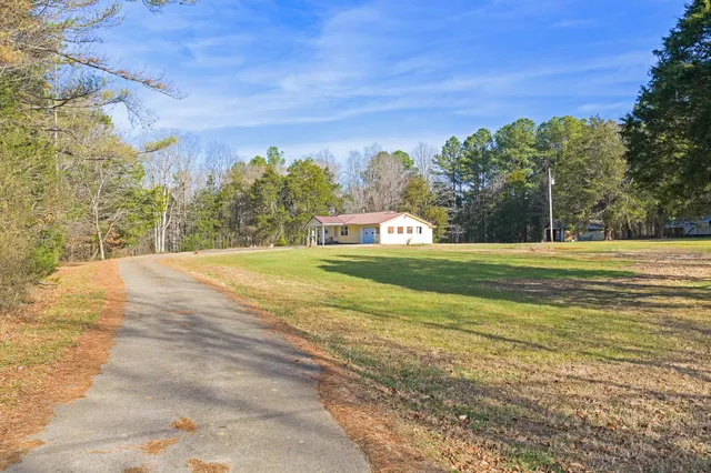 a view of a field with a building in the background