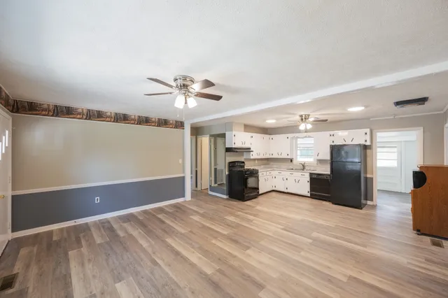 a view of a kitchen with a sink and a refrigerator