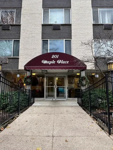 a view of a house with a small yard and wooden fence