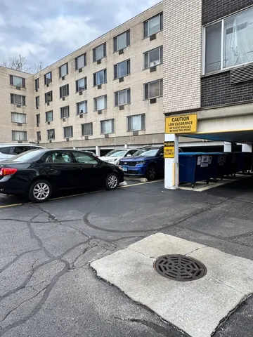 a view of a building with cars