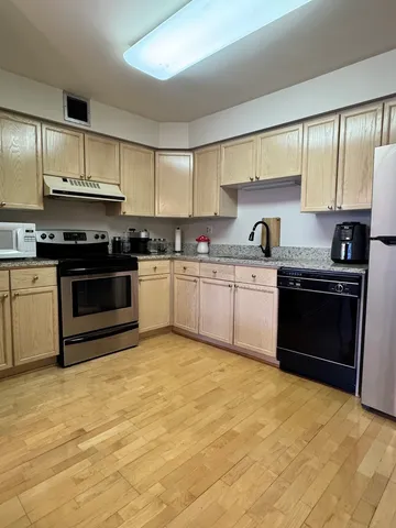 a kitchen with stainless steel appliances granite countertop a stove and a sink