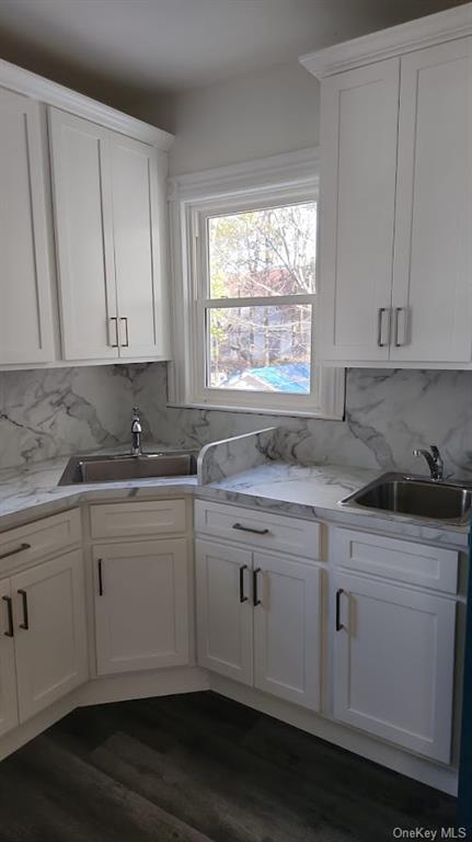 69 Saddle River Road, Unit #1 Monsey, NY 10952 - Photo 2 of 7 Kitchen with white cabinetry, dark wood-type flooring, and sink