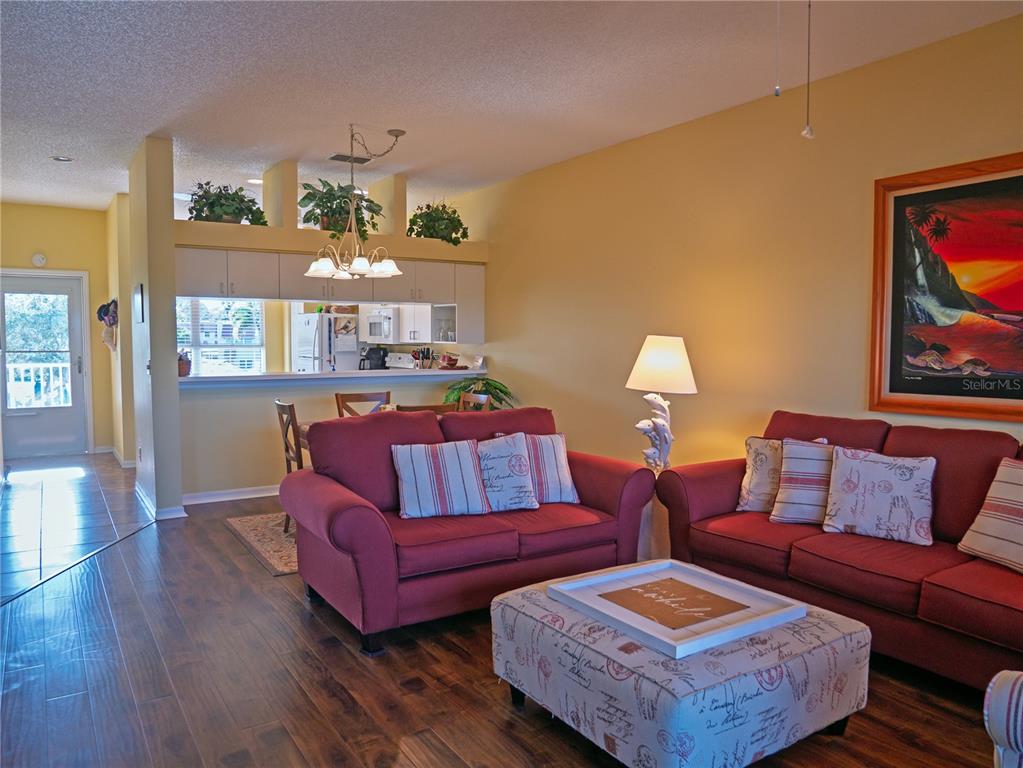 6401 99th Way North, Unit 15C St. Petersburg, FL 33708 - Photo 14 of 48 a living room with furniture and wooden floor