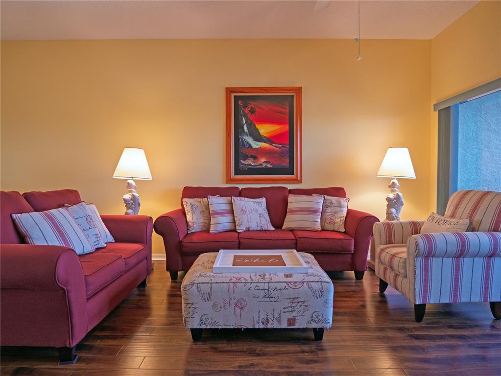 6401 99th Way North, Unit 15C St. Petersburg, FL 33708 - Photo 16 of 48 a living room with furniture and wooden floor