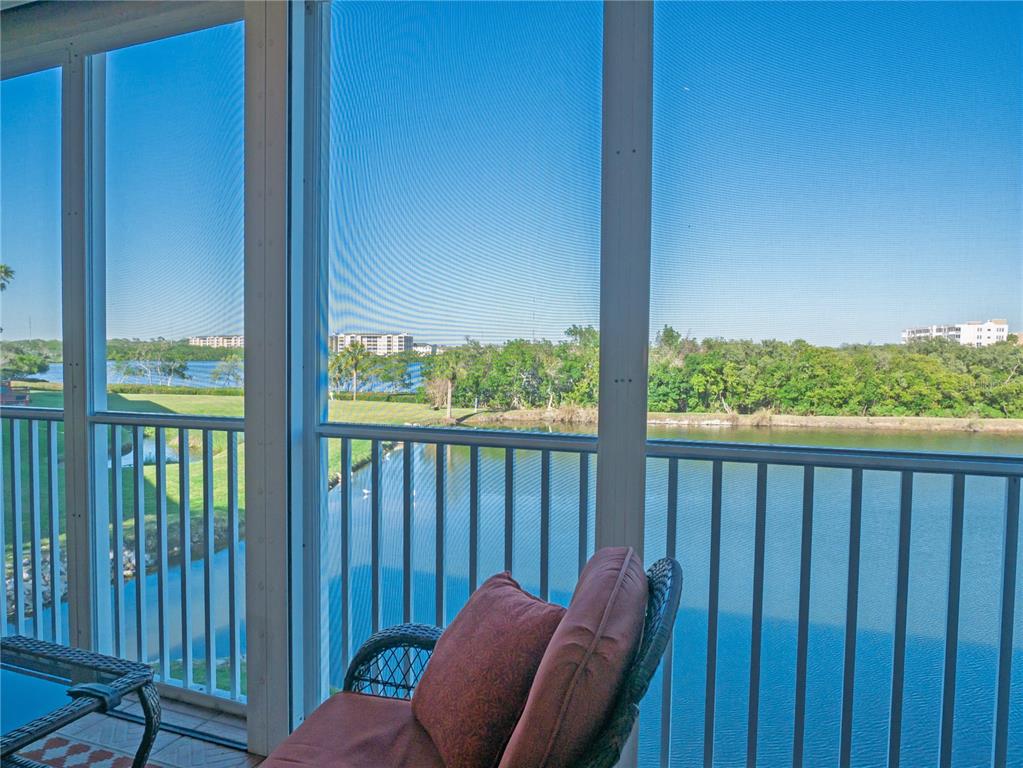 6401 99th Way North, Unit 15C St. Petersburg, FL 33708 - Photo 18 of 48 a view of a balcony with furniture