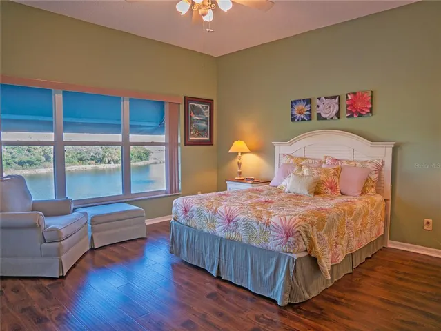 a bedroom with a bed and a large window