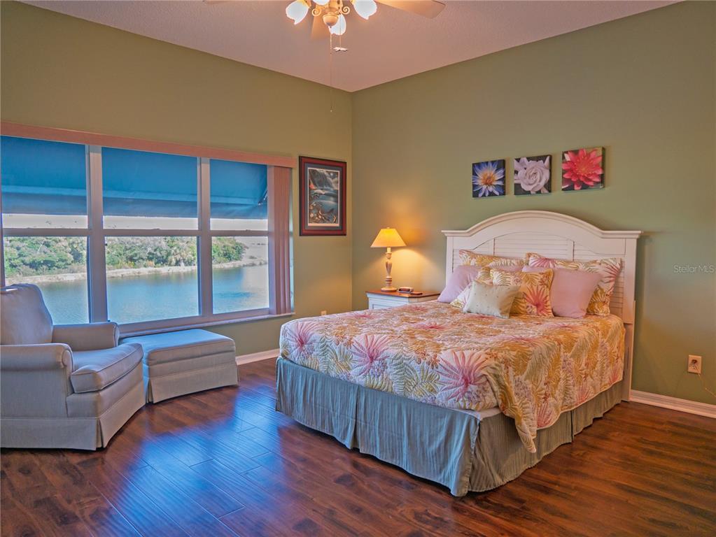 6401 99th Way North, Unit 15C St. Petersburg, FL 33708 - Photo 21 of 48 a bedroom with a bed and a large window