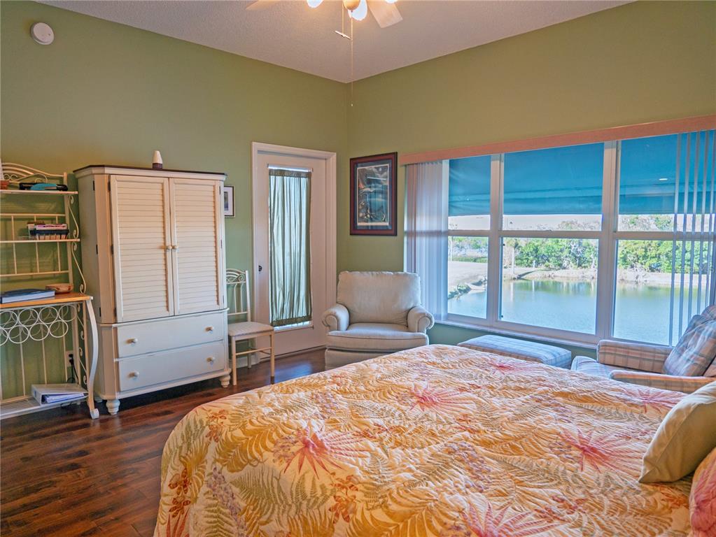 6401 99th Way North, Unit 15C St. Petersburg, FL 33708 - Photo 22 of 48 a bedroom with a bed and large windows