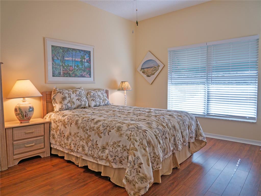 6401 99th Way North, Unit 15C St. Petersburg, FL 33708 - Photo 27 of 48 a bedroom with a bed and a night stand