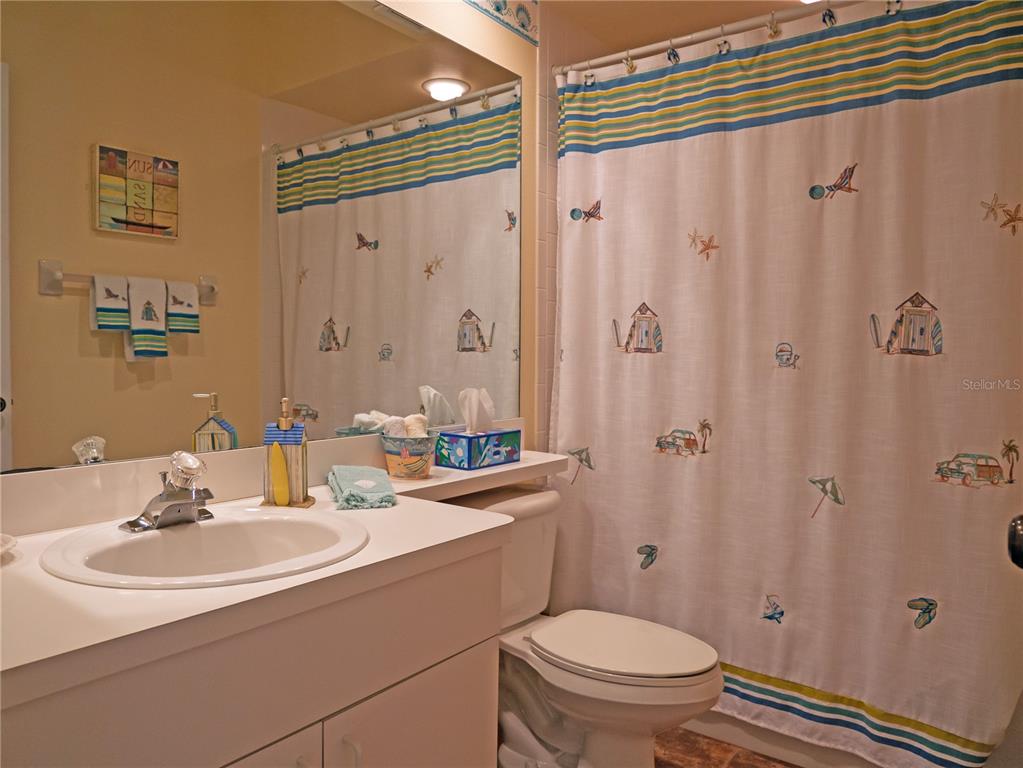 6401 99th Way North, Unit 15C St. Petersburg, FL 33708 - Photo 29 of 48 a bathroom with a sink toilet and shower
