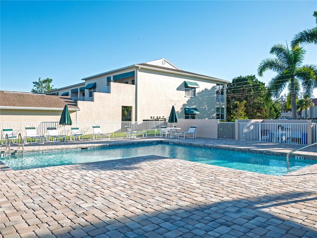 6401 99th Way North, Unit 15C St. Petersburg, FL 33708 - Photo 36 of 48 a view of swimming pool with outdoor seating