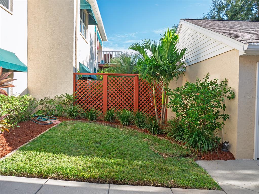6401 99th Way North, Unit 15C St. Petersburg, FL 33708 - Photo 39 of 48 a house view with a garden