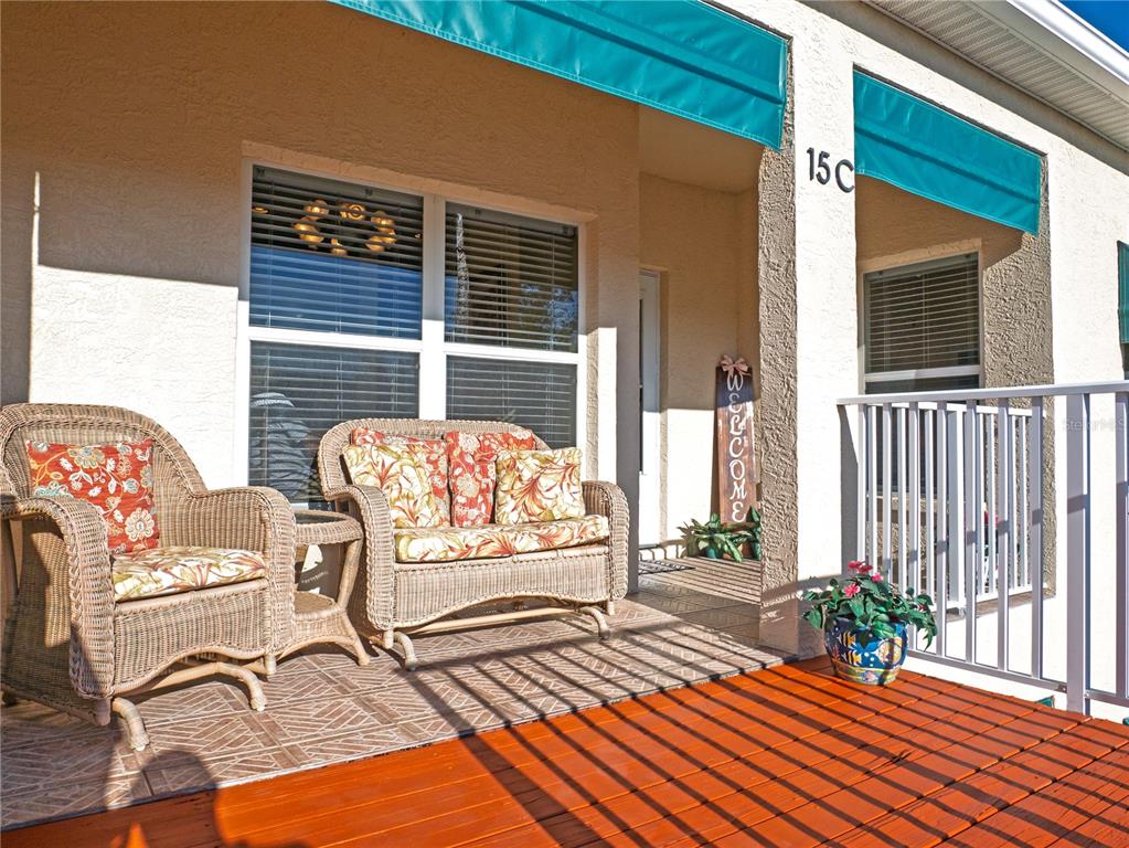 6401 99th Way North, Unit 15C St. Petersburg, FL 33708 - Photo 4 of 48 a view of a two chairs in the porch