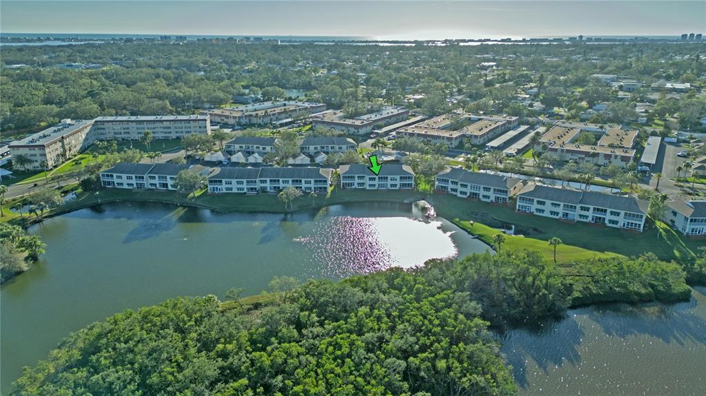 6401 99th Way North, Unit 15C St. Petersburg, FL 33708 - Photo 41 of 48 an aerial view of a house with a lake view