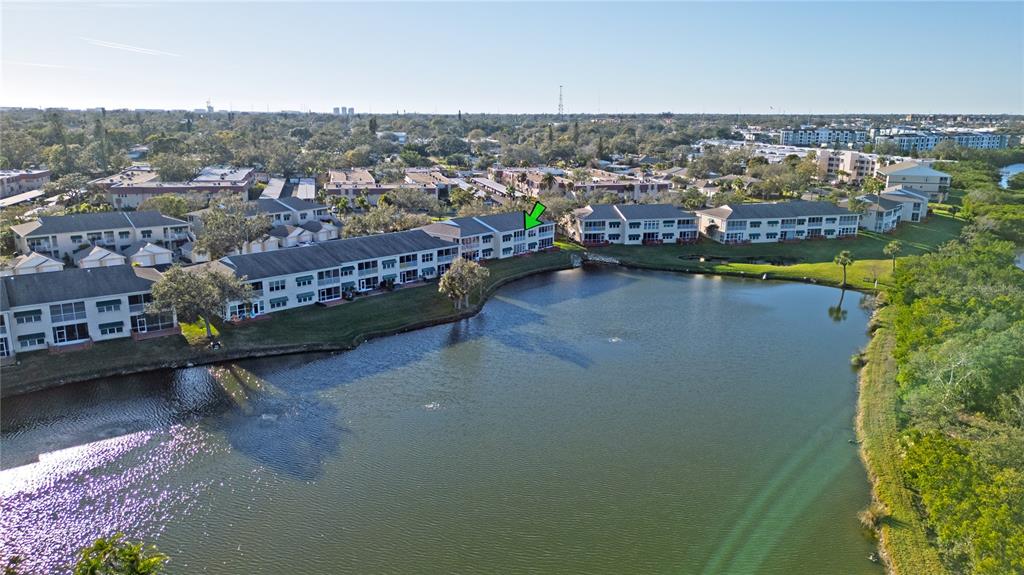 6401 99th Way North, Unit 15C St. Petersburg, FL 33708 - Photo 46 of 48 an aerial view of a city with lots of residential buildings ocean and mountain view in back