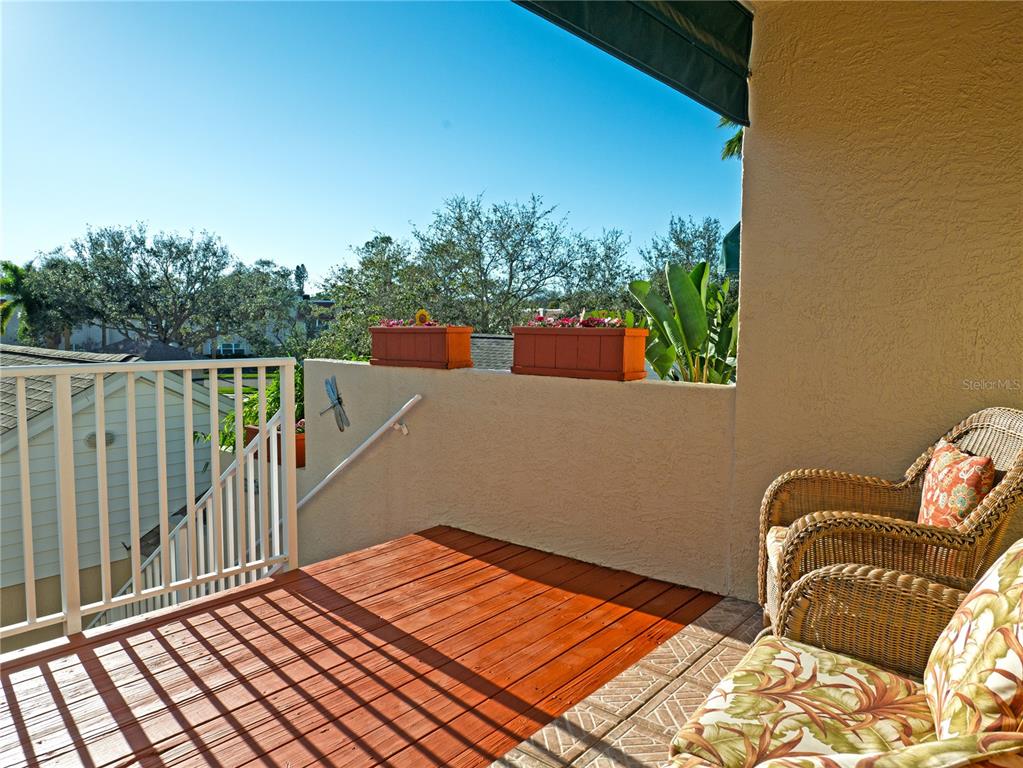 6401 99th Way North, Unit 15C St. Petersburg, FL 33708 - Photo 5 of 48 a balcony with view of an outdoor space