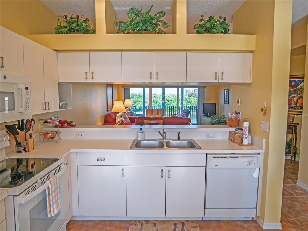 6401 99th Way North, Unit 15C St. Petersburg, FL 33708 - Photo 8 of 48 a kitchen with a sink stove and cabinets