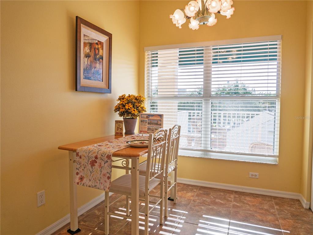6401 99th Way North, Unit 15C St. Petersburg, FL 33708 - Photo 9 of 48 a dining room with furniture and window