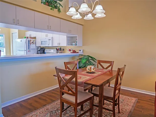 a view of a dining room with furniture and chandelier
