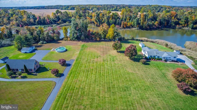 a view of swimming pool with a table and chairs potted plants