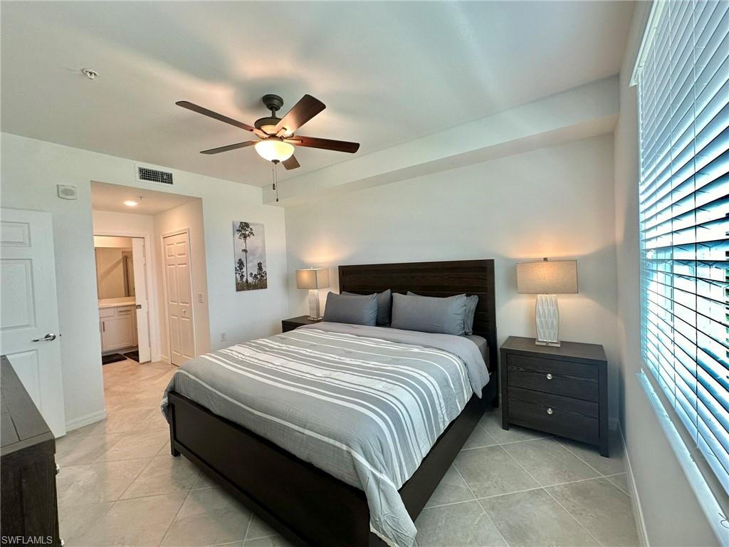 43985 Boardwalk Loop, Unit 2115 Babcock Ranch, FL 33982 - Photo 13 of 42 a bedroom with a bed and a lamp