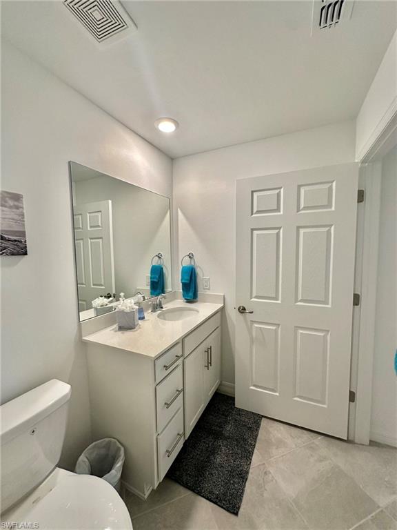 43985 Boardwalk Loop, Unit 2115 Babcock Ranch, FL 33982 - Photo 18 of 42 a bathroom with a sink toilet and mirror