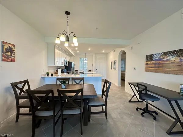a view of a dining room with furniture and a chandelier