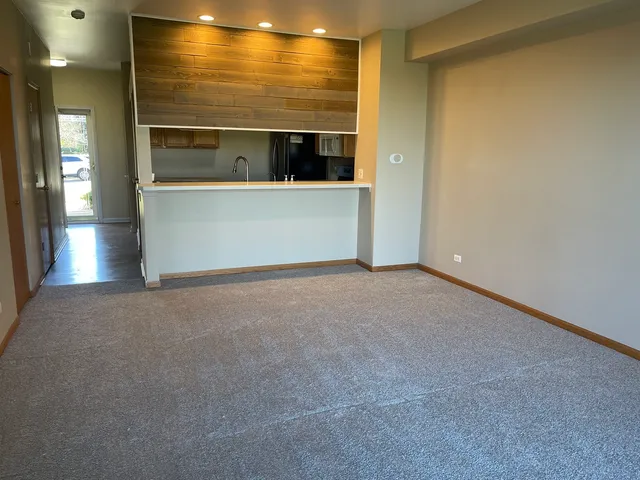 a view of an empty room and a window