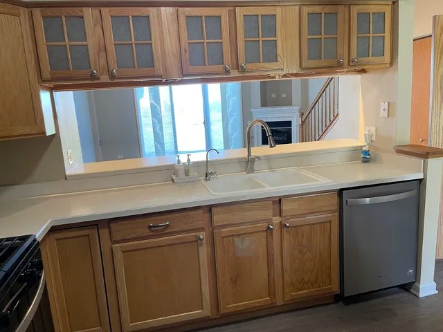 a view of a hallway with wooden floor and stairs