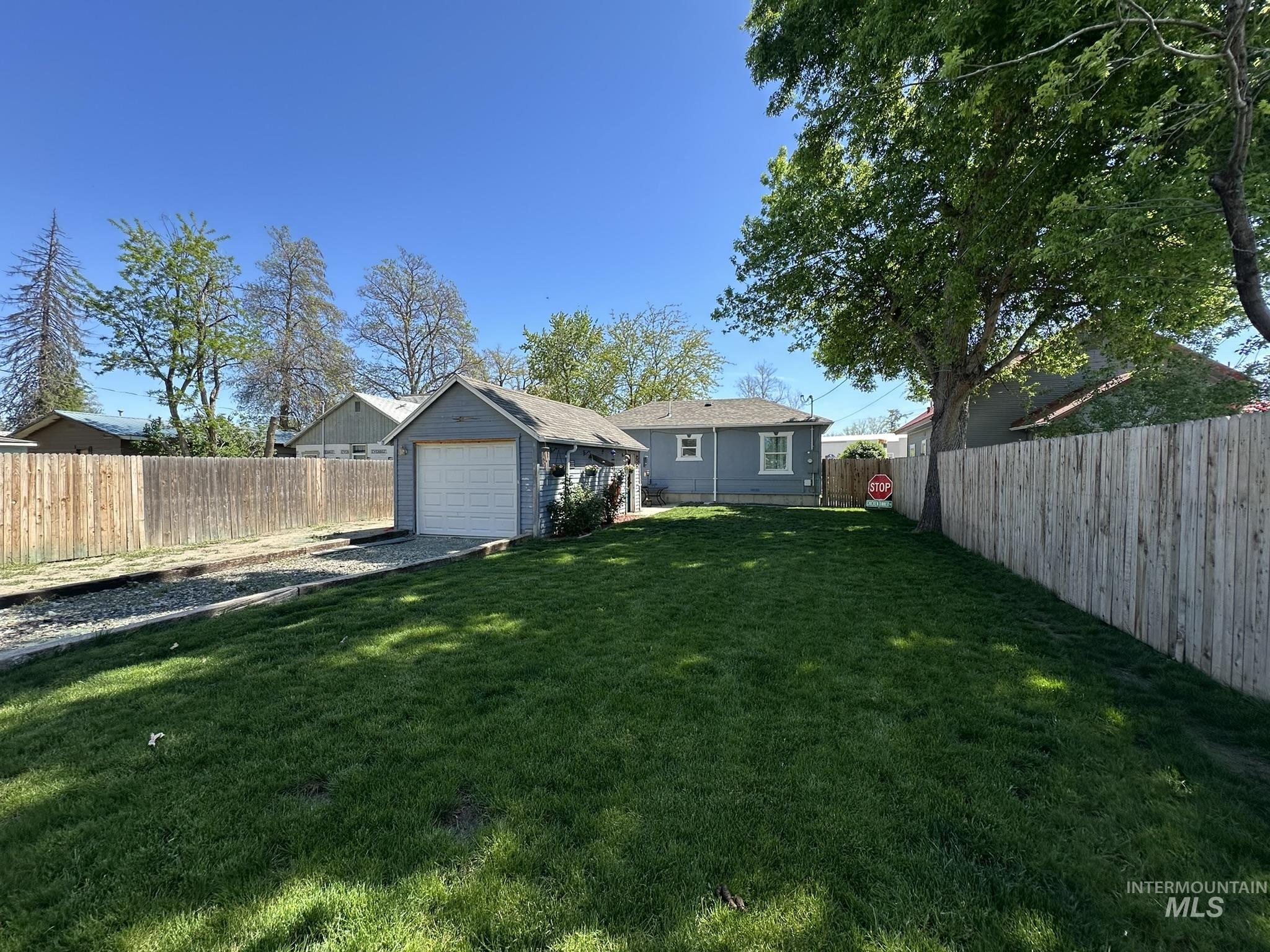 409 North 7th Street Payette, ID 83661 - Photo 17 of 23 Expansive lawn area with a detached garage structure and a privacy fence