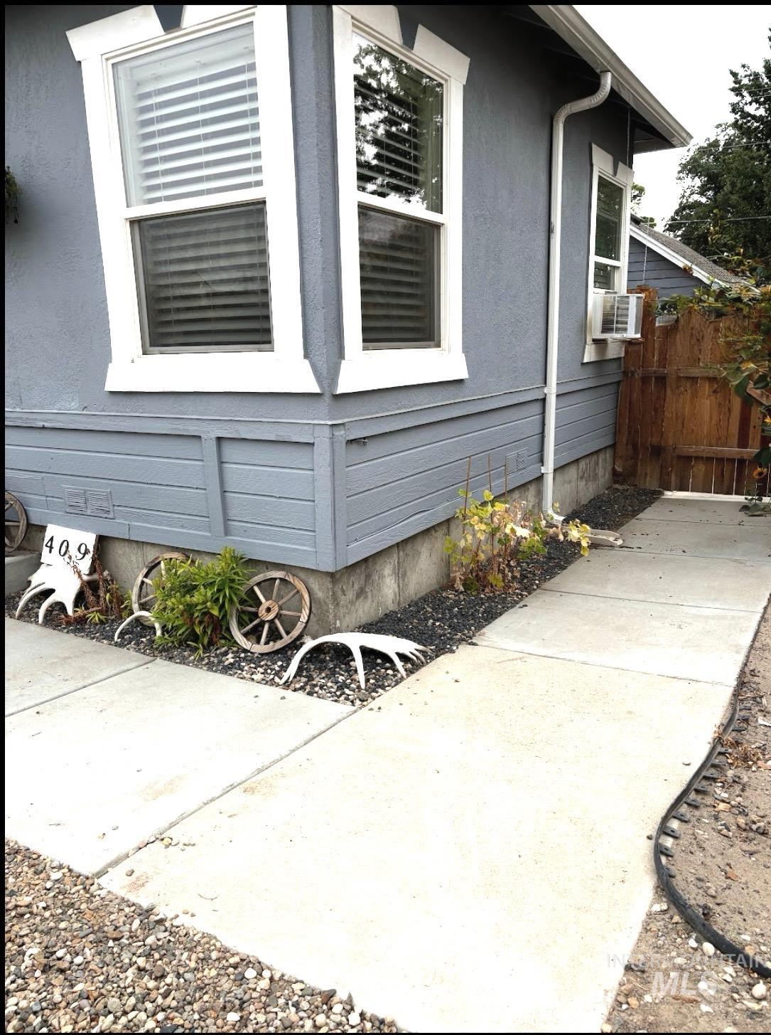 409 North 7th Street Payette, ID 83661 - Photo 6 of 23 Exterior wall featuring gray stucco siding and white trim around windows