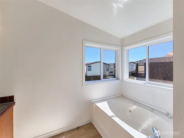 a bathroom with a bathtub and window