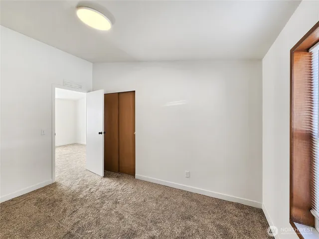 an empty room with closet area