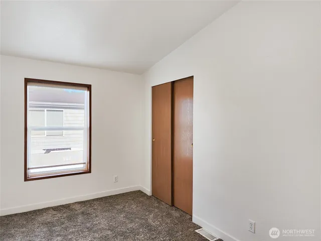 a view of an empty room and closet